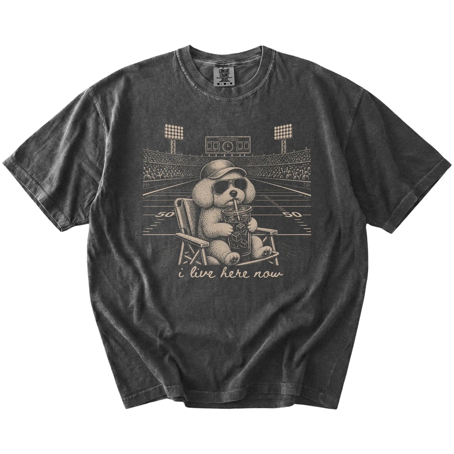 Bichon Frise claiming the football field with “I Live Here Now” lettering on a Pepper Comfort Colors® T-shirt