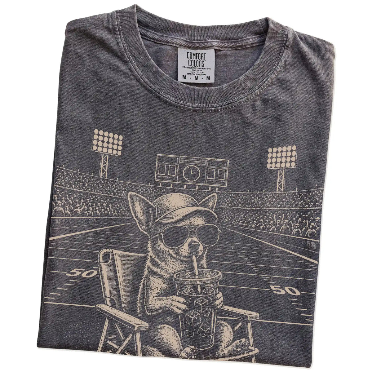 Folded Pepper Comfort Colors® T-shirt showing Chihuahua claiming the football field with “I Live Here Now” lettering