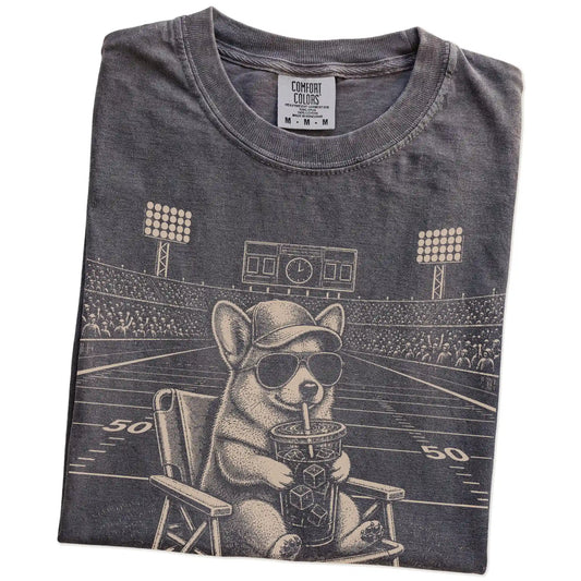 Folded Pepper Comfort Colors® T-shirt showing Corgi claiming the football field with “I Live Here Now” lettering