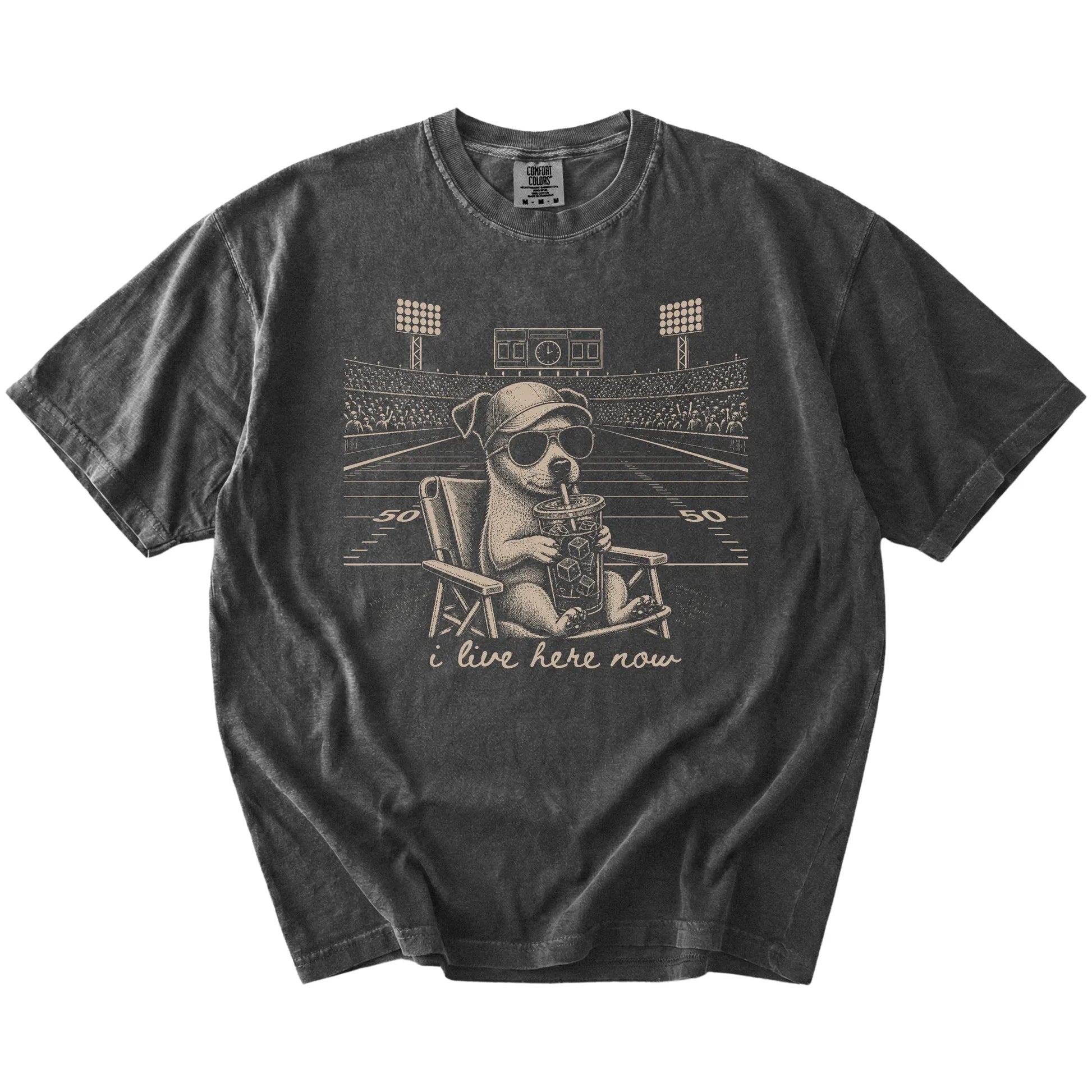 Jack Russell claiming the football field with “I Live Here Now” lettering on a Pepper Comfort Colors® T-shirt