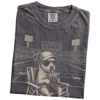 Folded Pepper Comfort Colors® T-shirt showing Jack Russell claiming the football field with “I Live Here Now” lettering