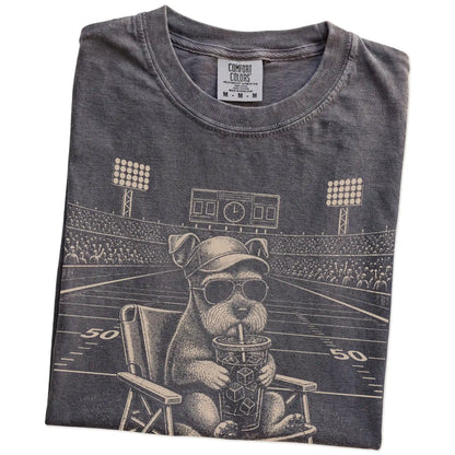 Folded Pepper Comfort Colors® T-shirt showing Schnauzer claiming the football field with “I Live Here Now” lettering