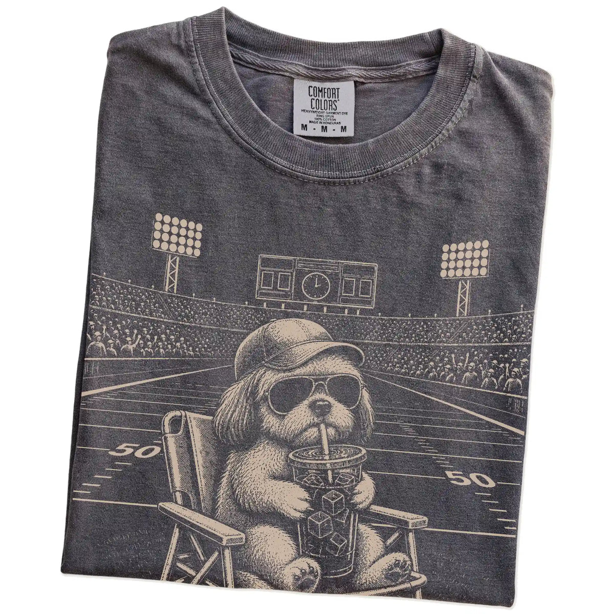 Folded Pepper Comfort Colors® T-shirt showing Shih Tzu claiming the football field with “I Live Here Now” lettering