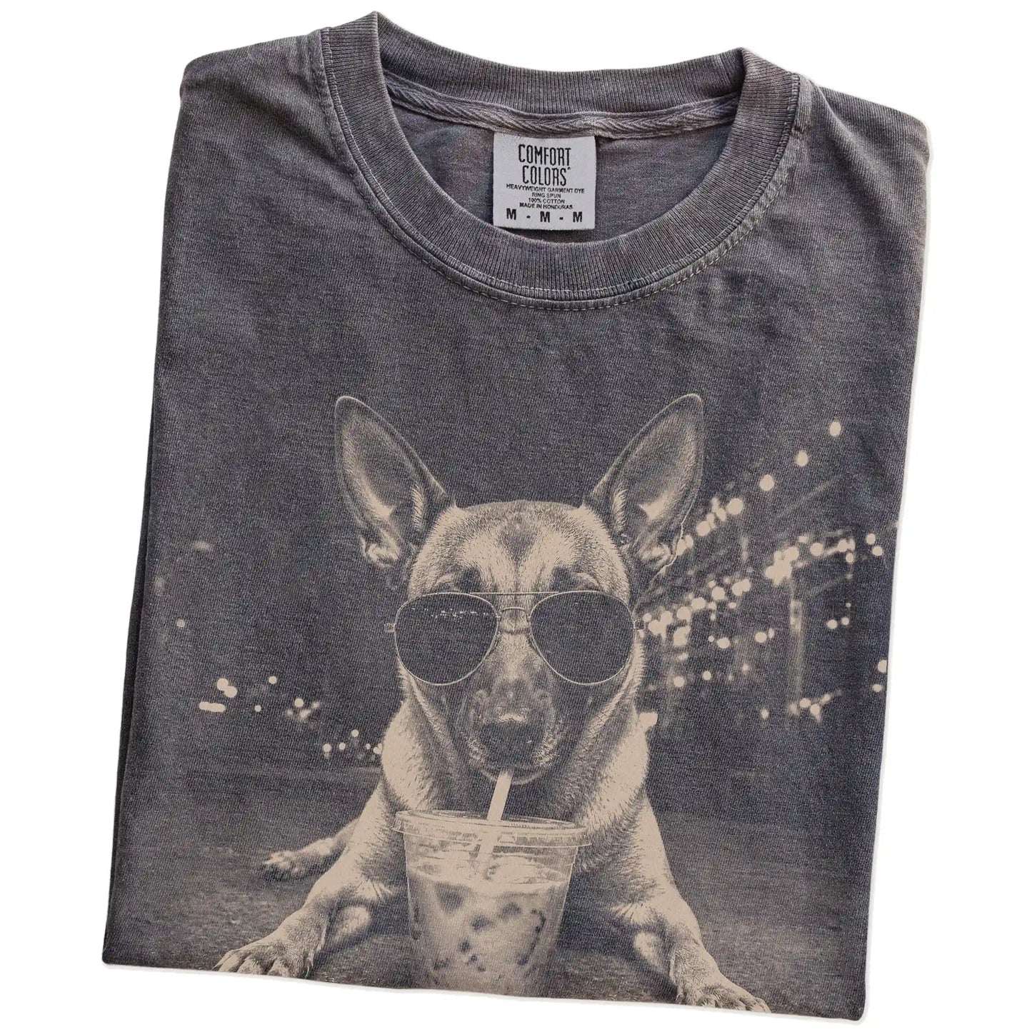 Folded Pepper Comfort Colors® T-shirt showing Belgian Malinois with iced coffee in a retro grunge design