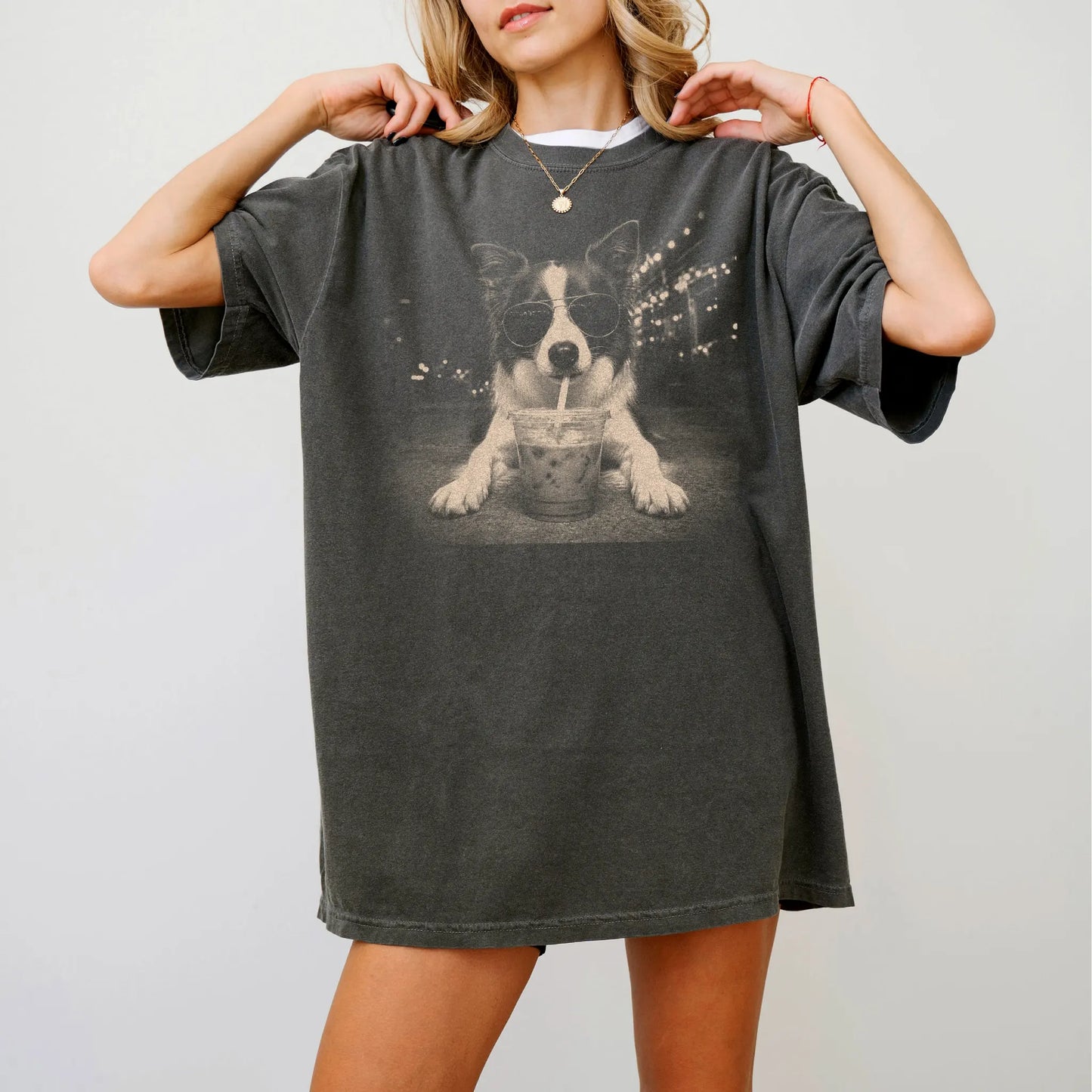 Model wearing a Pepper Comfort Colors® T-shirt featuring Border Collie with iced coffee in a retro grunge design