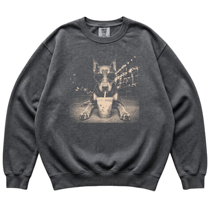 Doberman wearing aviator sunglasses and drinking iced coffee on a Pepper Comfort Colors 1566 Sweatshirt, flat lay view
