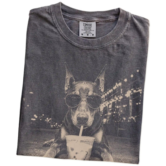 Folded Pepper Comfort Colors® T-shirt showing Doberman with iced coffee in a retro grunge design