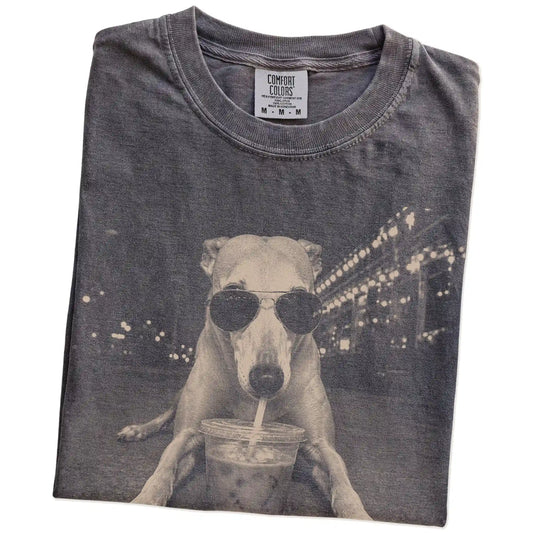 Folded Pepper Comfort Colors® T-shirt showing Greyhound with iced coffee in a retro grunge design