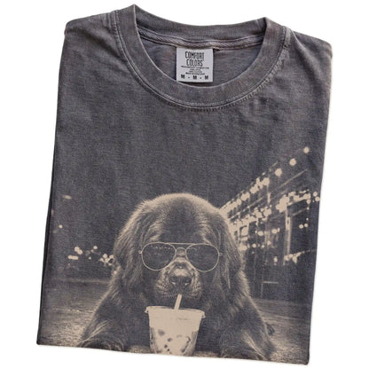 Folded Pepper Comfort Colors® T-shirt showing Newfie with iced coffee in a retro grunge design