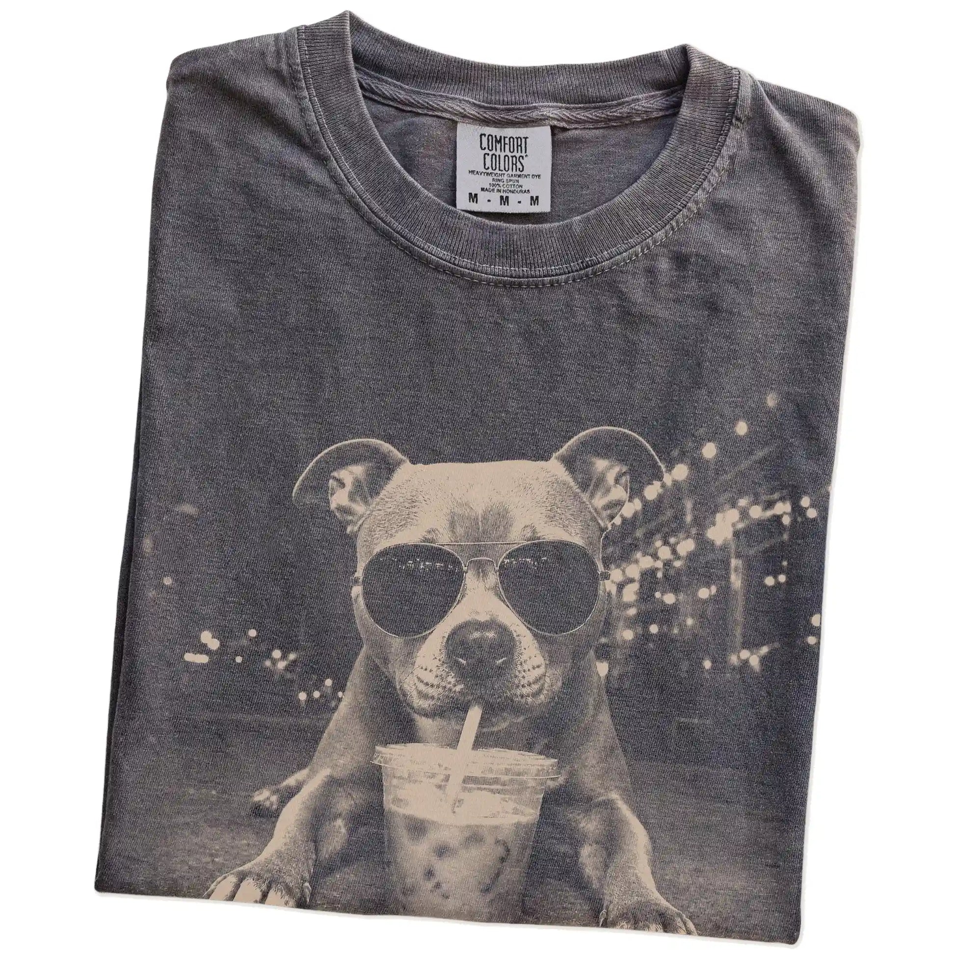 Folded Pepper Comfort Colors® T-shirt showing Pitbull with iced coffee in a retro grunge design