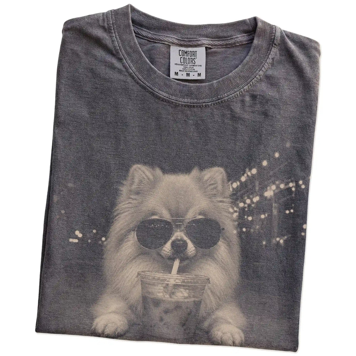 Folded Pepper Comfort Colors® T-shirt showing Pomeranian with iced coffee in a retro grunge design