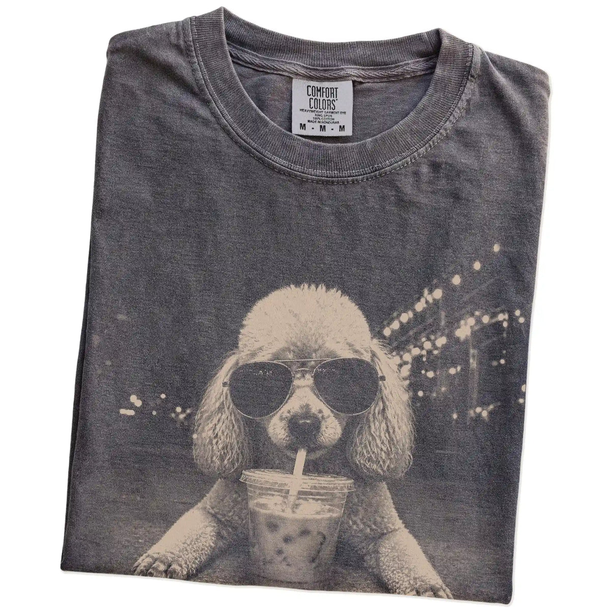 Folded Pepper Comfort Colors® T-shirt showing Poodle with iced coffee in a retro grunge design