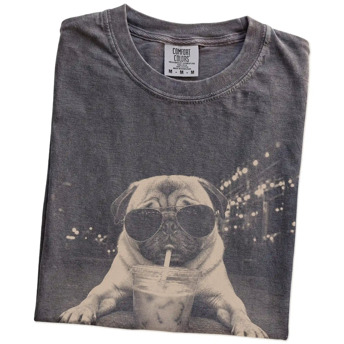 Folded Pepper Comfort Colors® T-shirt showing Pug with iced coffee in a retro grunge design