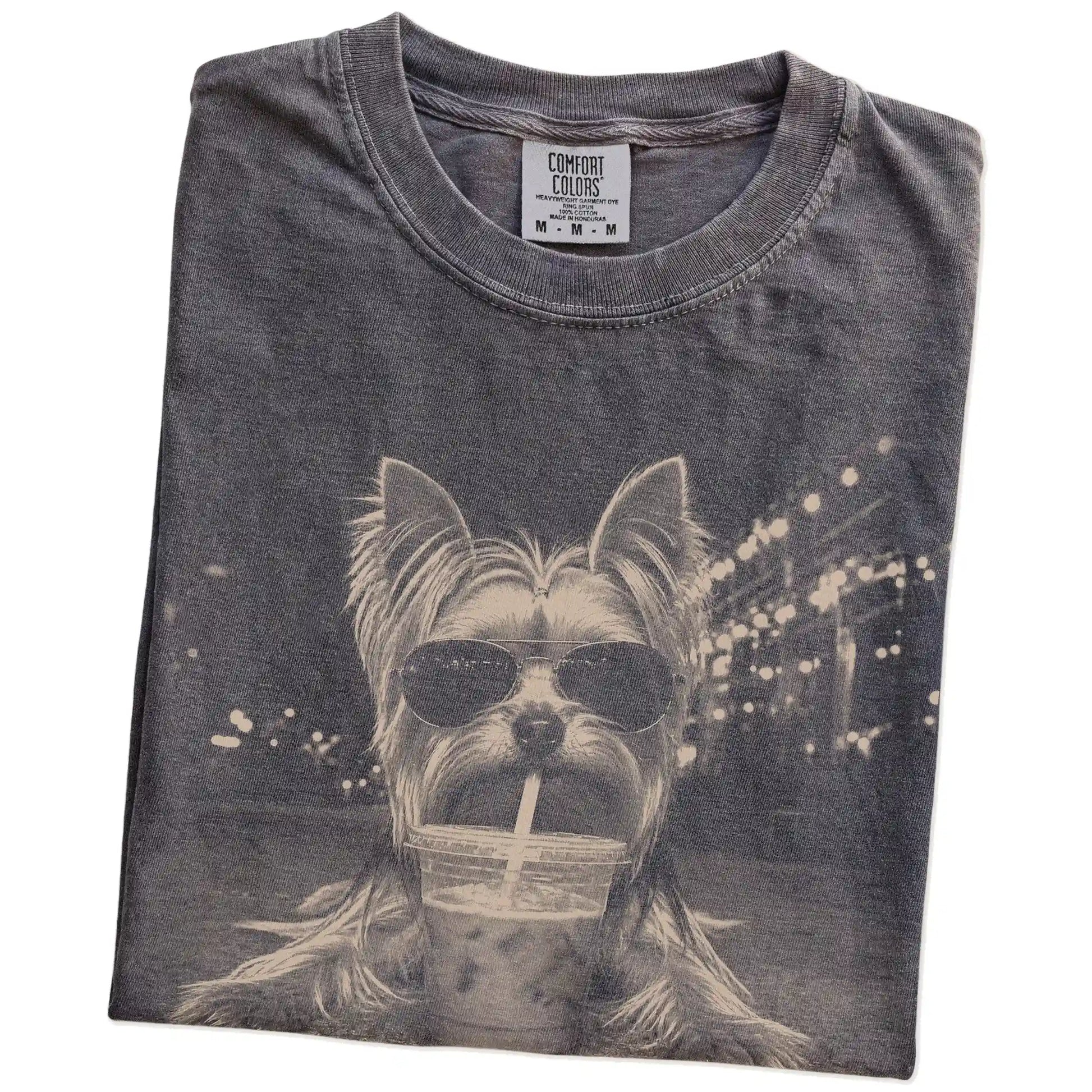 Folded Pepper Comfort Colors® T-shirt showing Yorkshire Terrier with iced coffee in a retro grunge design