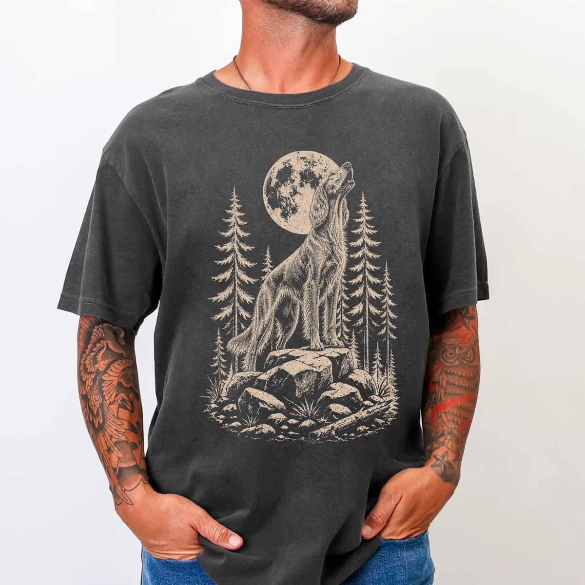 Model wearing a Pepper Comfort Colors® T-shirt with a Irish Setter howling beneath the moon and pine trees