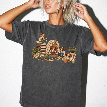 Jack Russell puppies reading books in a cozy blanket fort on a Pepper T-shirt worn by a model