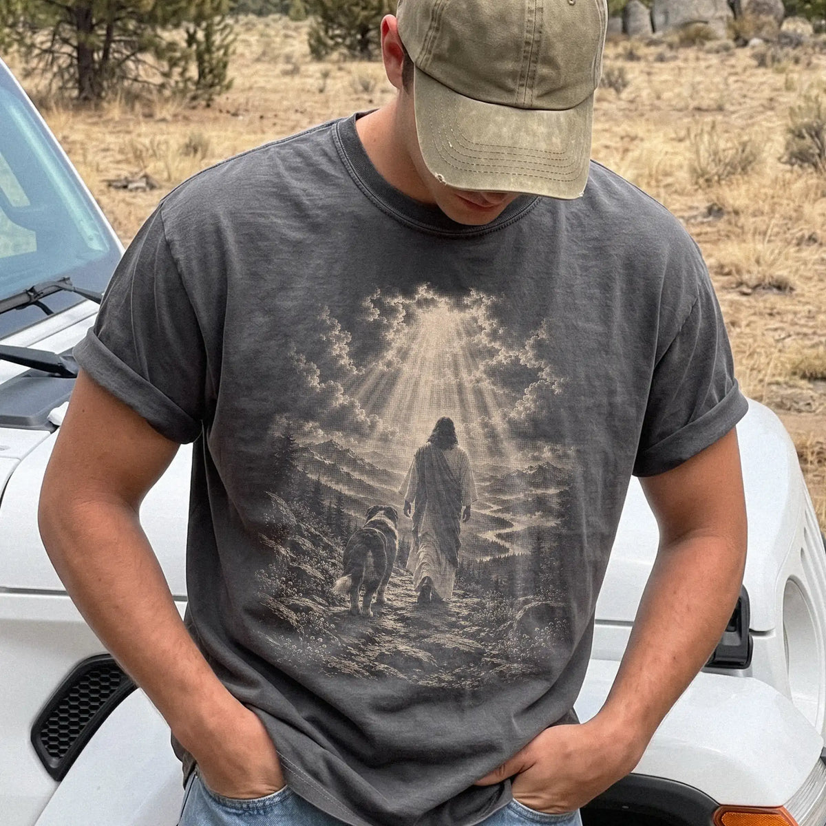 Person wearing a Pepper T-shirt with Jesus walking beside a Bernese Mountain Dog beneath rays of light