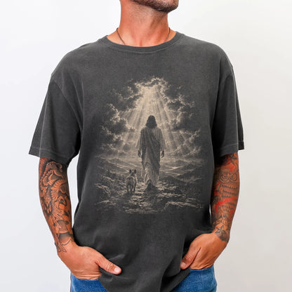 Person wearing a Pepper T-shirt with Jesus walking beside a French Bulldog beneath rays of light