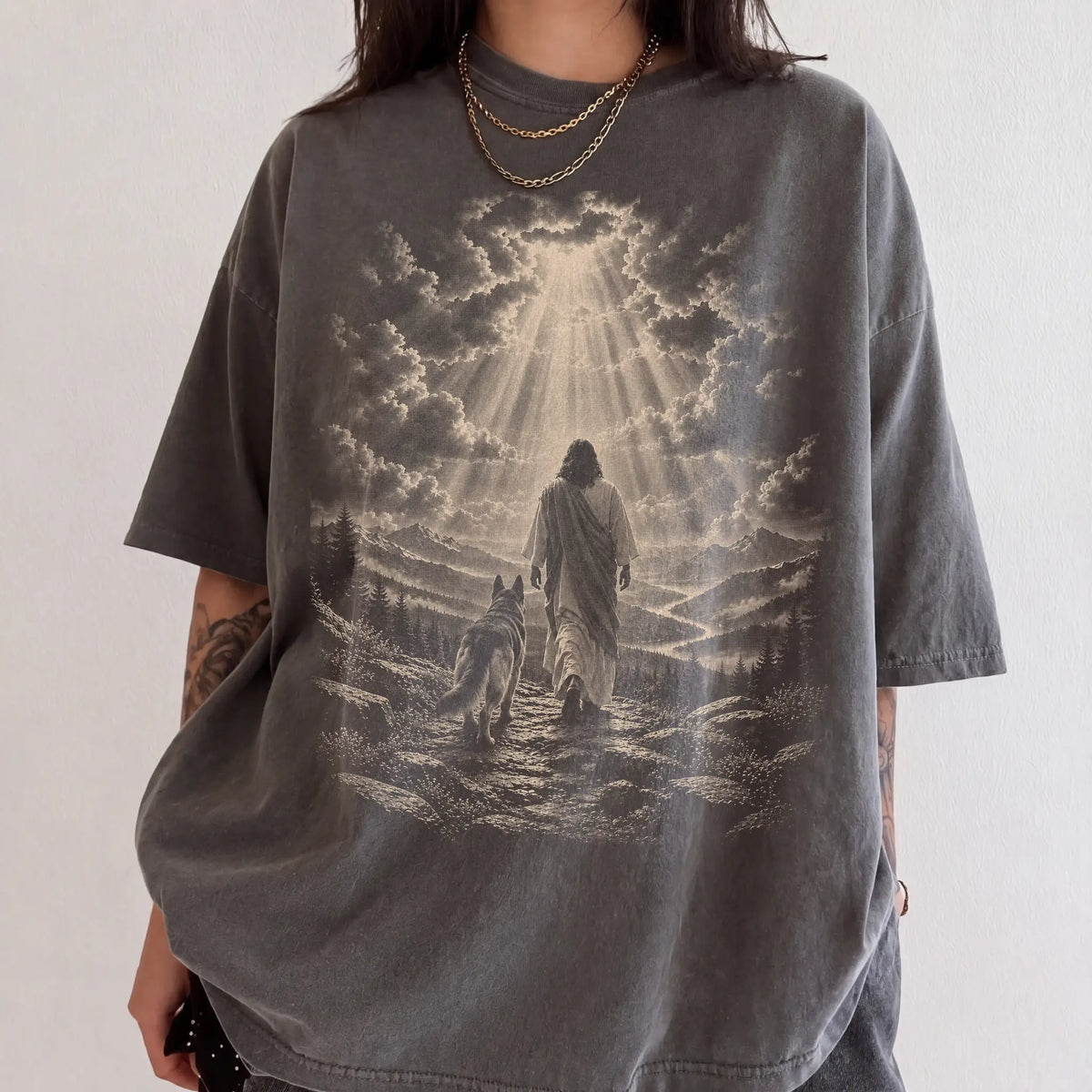 Person wearing a Pepper T-shirt with Jesus walking beside a German Shepherd beneath rays of light