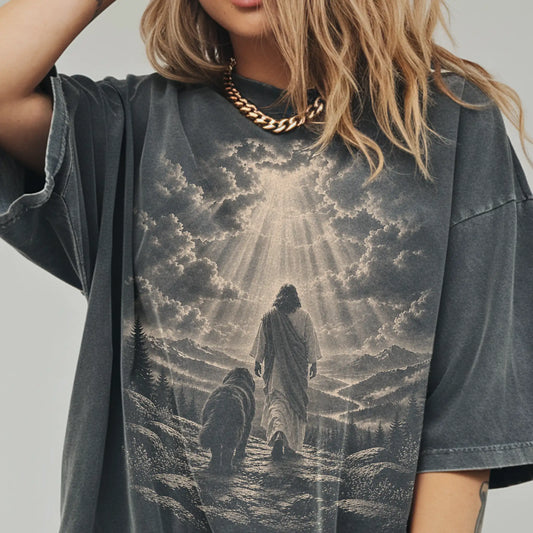 Person wearing a Pepper T-shirt with Jesus walking beside a Newfie beneath rays of light