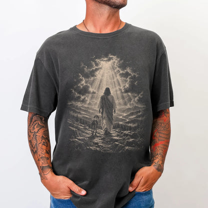 Person wearing a Pepper T-shirt with Jesus walking beside a Vizsla beneath rays of light