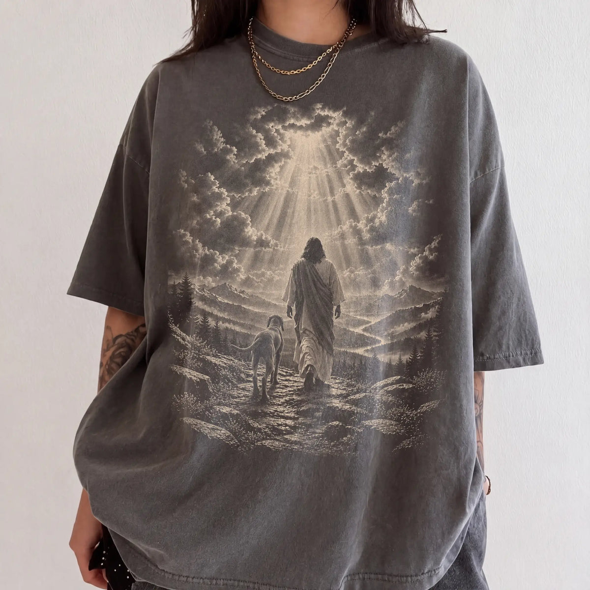 Person wearing a Pepper T-shirt with Jesus walking beside a Weimaraner beneath rays of light