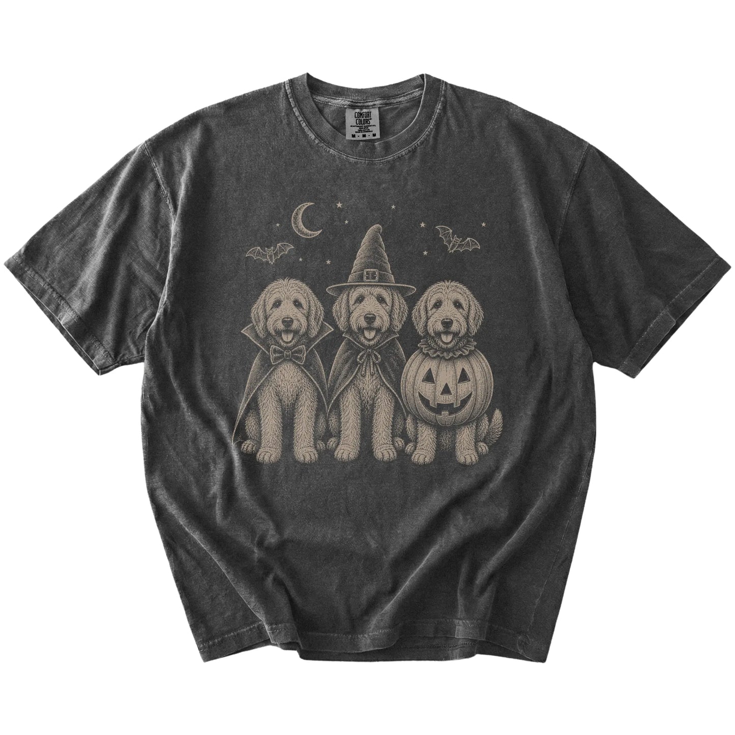 Three Labradoodle dogs dressed for Halloween beneath bats and a crescent moon on a Pepper Comfort Colors® T-shirt