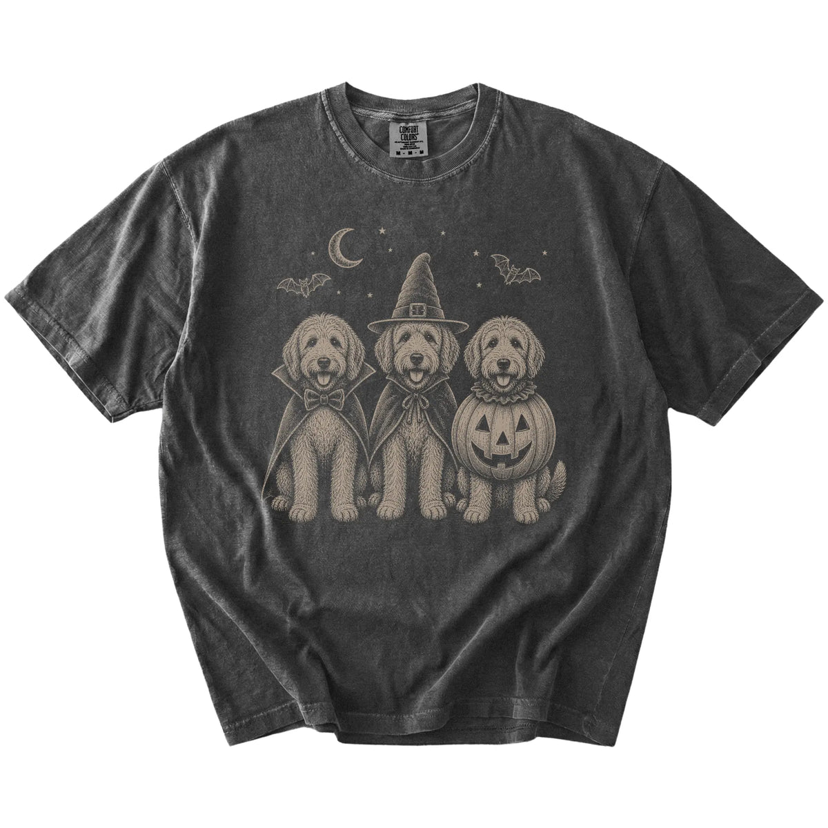 Three Labradoodle dogs dressed for Halloween beneath bats and a crescent moon on a Pepper Comfort Colors® T-shirt