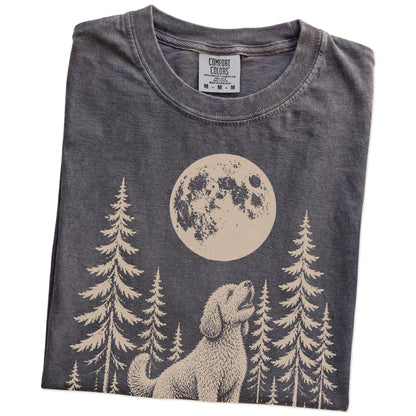 Folded Pepper Comfort Colors® T-shirt showing a Labradoodle howling beneath the moon and pine trees