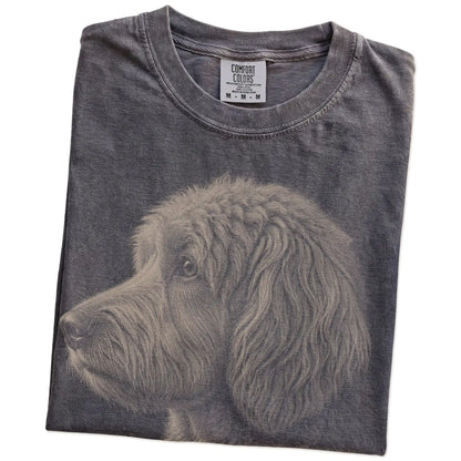 Folded Pepper Comfort Colors® T-shirt showing a detailed photographic portrait of a Labradoodle