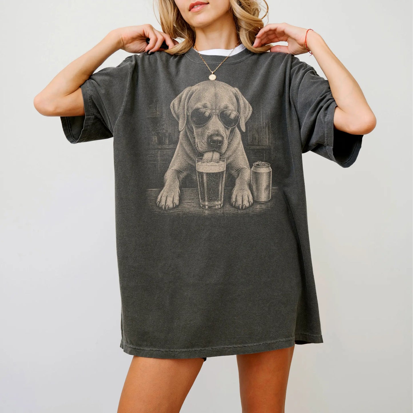 Model wearing a Pepper Comfort Colors® t-shirt with Labrador Retriever sneaking a drink from a pint