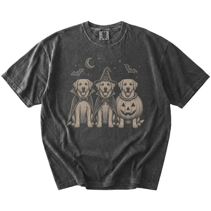 Three Labrador Retriever dogs dressed for Halloween beneath bats and a crescent moon on a Pepper Comfort Colors® T-shirt