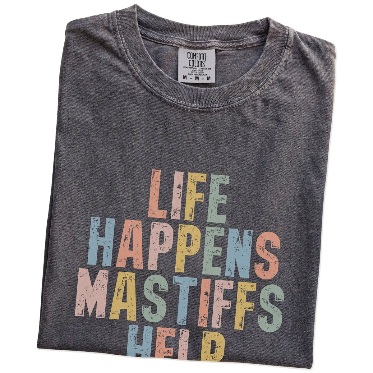 Folded Pepper Comfort Colors® T-shirt showing Mastiff making hard days better with “Life Happens, Dogs Help” lettering