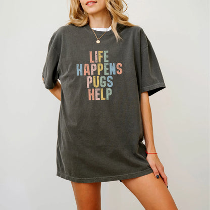 Model wearing a Pepper Comfort Colors® T-shirt featuring Pug making hard days better with “Life Happens, Dogs Help” lettering