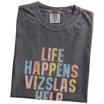 Folded Pepper Comfort Colors® T-shirt showing retro “Life Happens, Vizslas Help” lettering