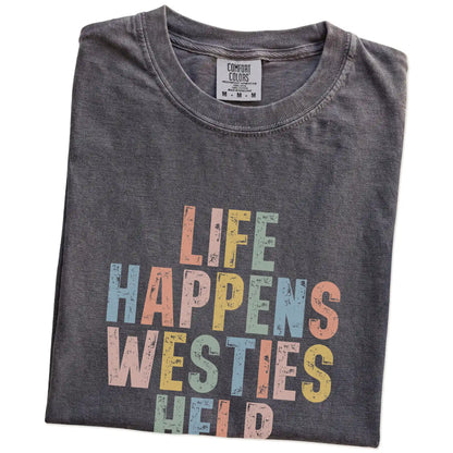 Folded Pepper Comfort Colors® T-shirt showing retro “Life Happens, Westies Help” lettering