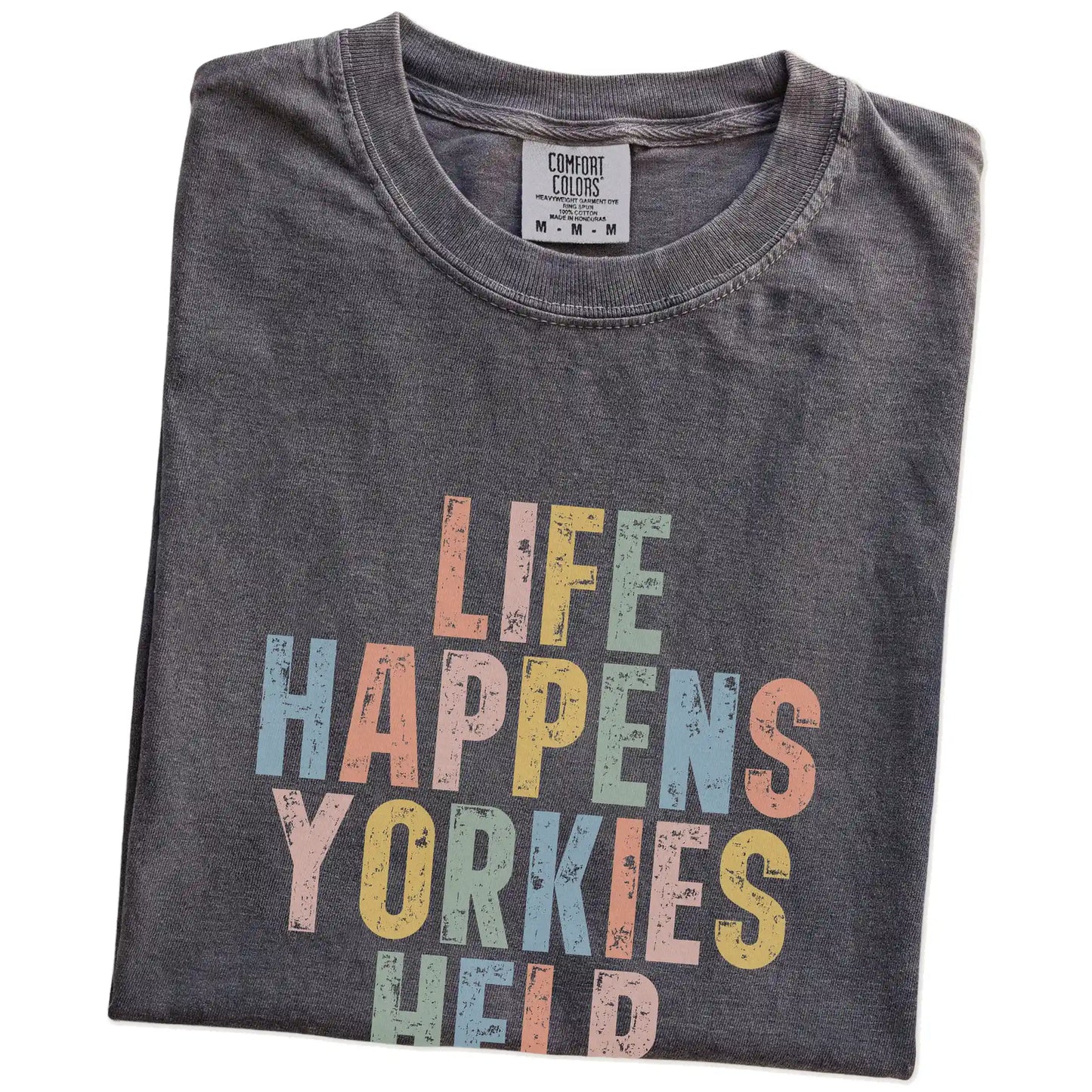Folded Pepper Comfort Colors® T-shirt showing retro “Life Happens, Yorkies Help” lettering