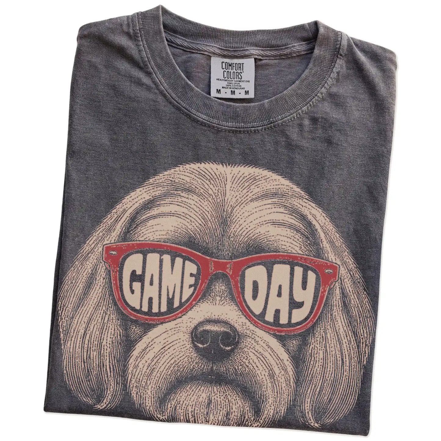 Folded Pepper Comfort Colors® T-shirt showing maltese wearing red game day sunglasses