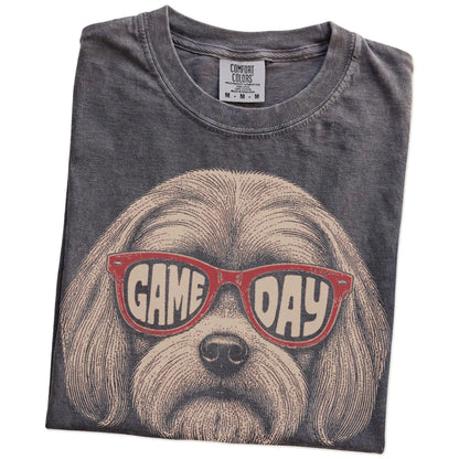 Folded Pepper Comfort Colors® T-shirt showing maltese wearing red game day sunglasses