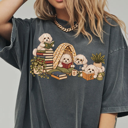 Maltese puppies reading books in a cozy blanket fort on a Pepper T-shirt worn by a model