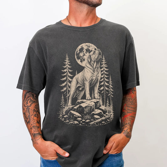 Model wearing a Pepper Comfort Colors® T-shirt with a Mastiff howling beneath the moon and pine trees