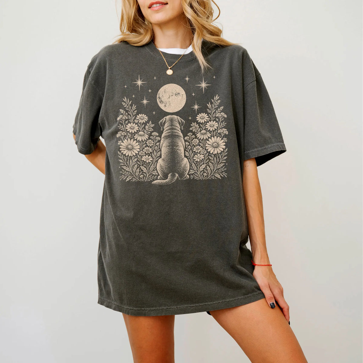 Model wearing a Pepper Comfort Colors® T-shirt featuring Mastiff beneath a wildflower moon