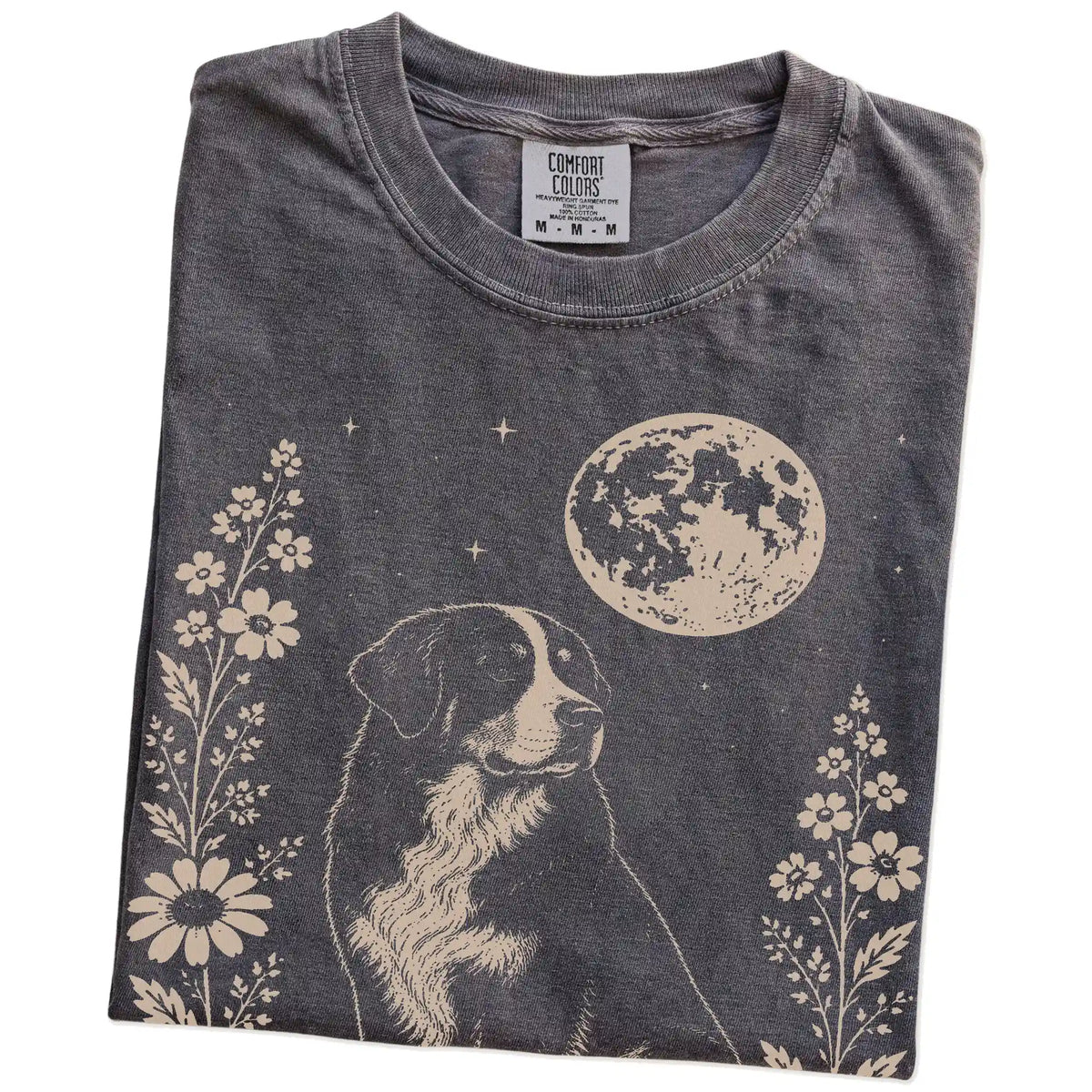 Folded Pepper Comfort Colors® T-shirt showing Bernese Mountain Dog framed by flowers beneath the moon