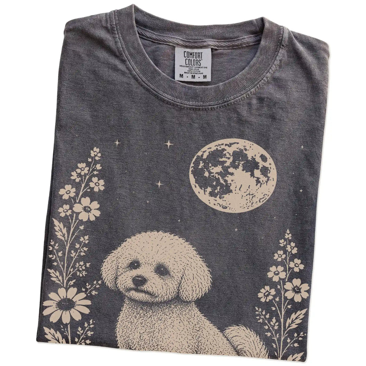 Folded Pepper Comfort Colors® T-shirt showing Bichon Frise framed by flowers beneath the moon