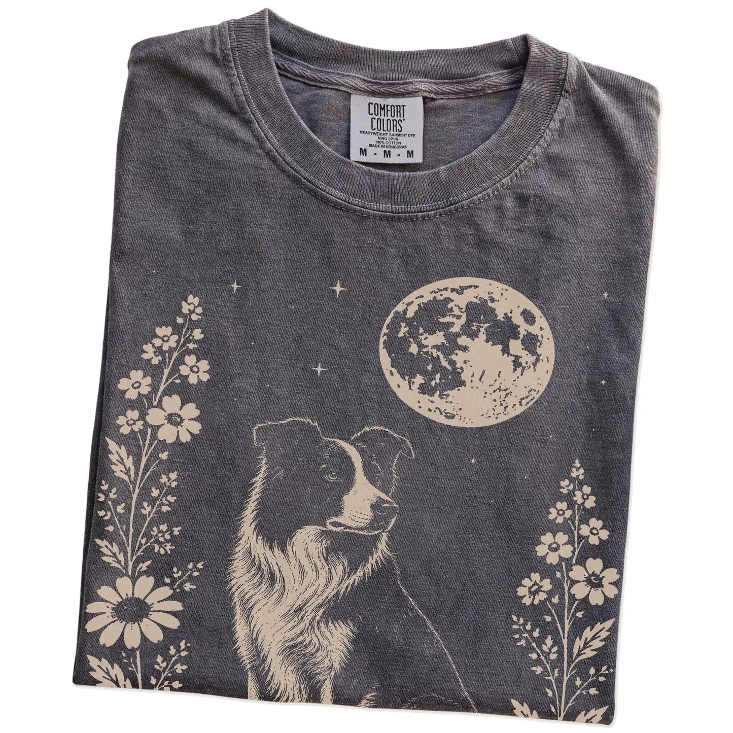 Folded Pepper Comfort Colors® T-shirt showing Border Collie framed by flowers beneath the moon