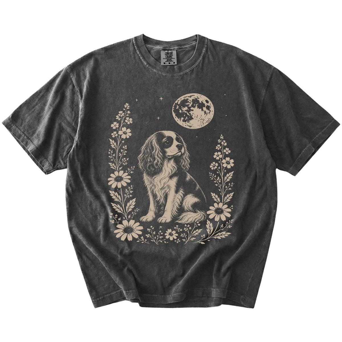 Cavalier King Charles Spaniel framed by flowers beneath the moon on a Pepper Comfort Colors® T-shirt