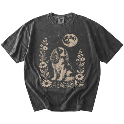 Cavalier King Charles Spaniel framed by flowers beneath the moon on a Pepper Comfort Colors® T-shirt