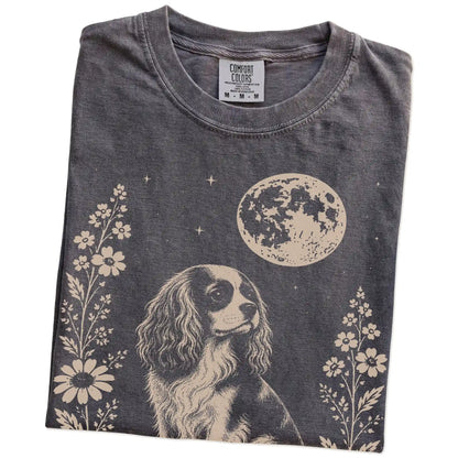 Folded Pepper Comfort Colors® T-shirt showing Cavalier King Charles Spaniel framed by flowers beneath the moon