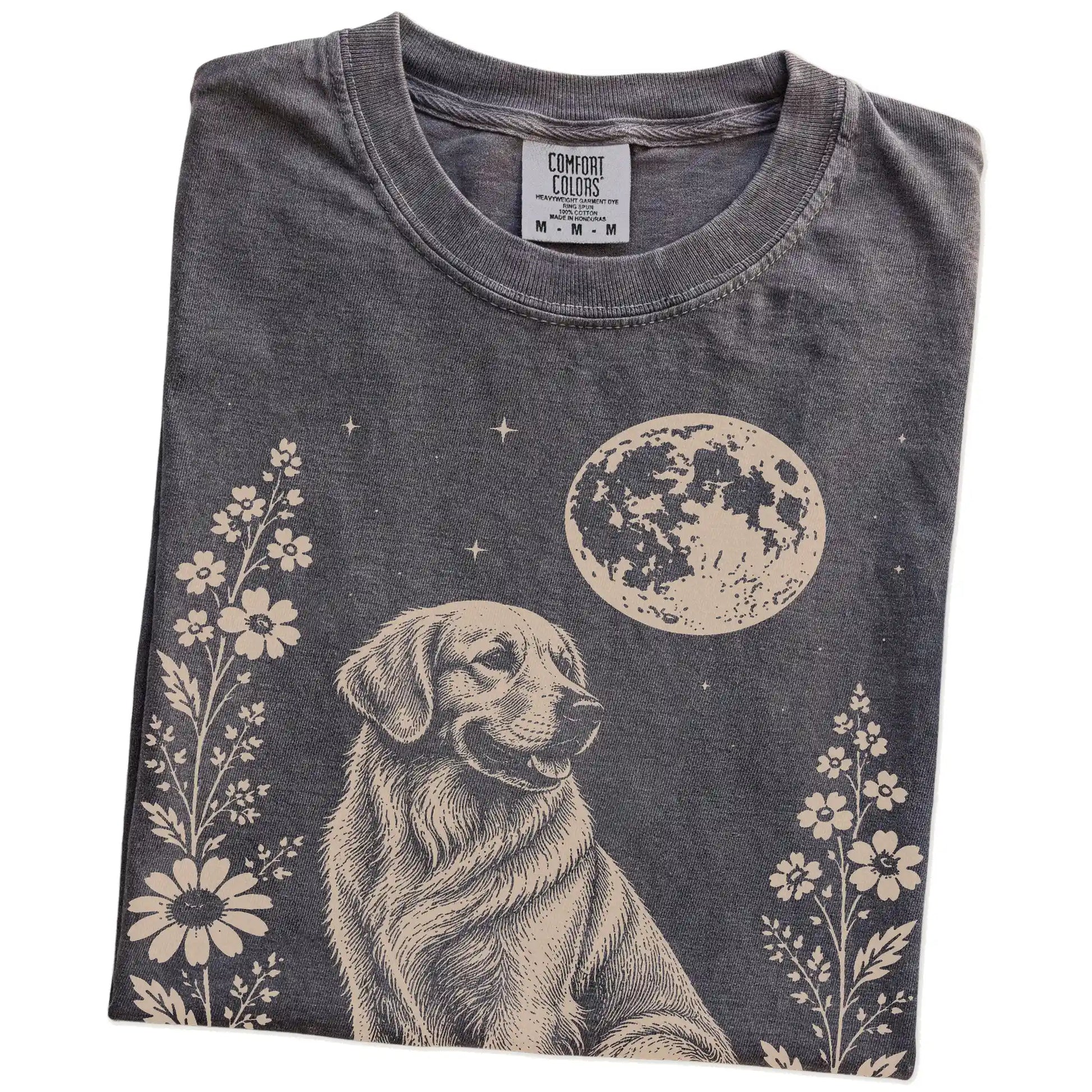 Folded Pepper Comfort Colors® T-shirt showing Golden Retriever framed by flowers beneath the moon