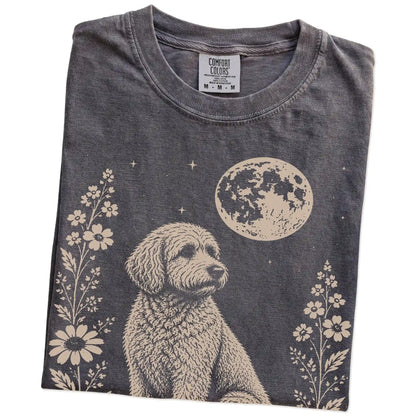 Folded Pepper Comfort Colors® T-shirt showing Goldendoodle framed by flowers beneath the moon